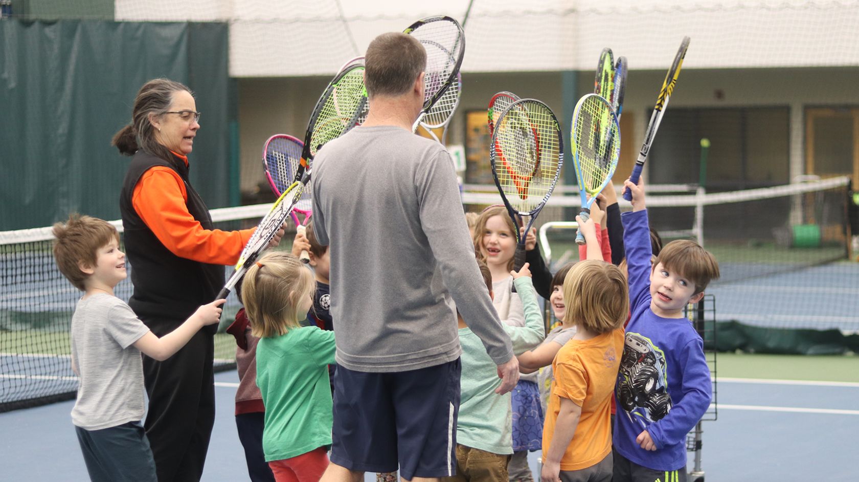 A Group Of Kids Holding Tennis Rackets
