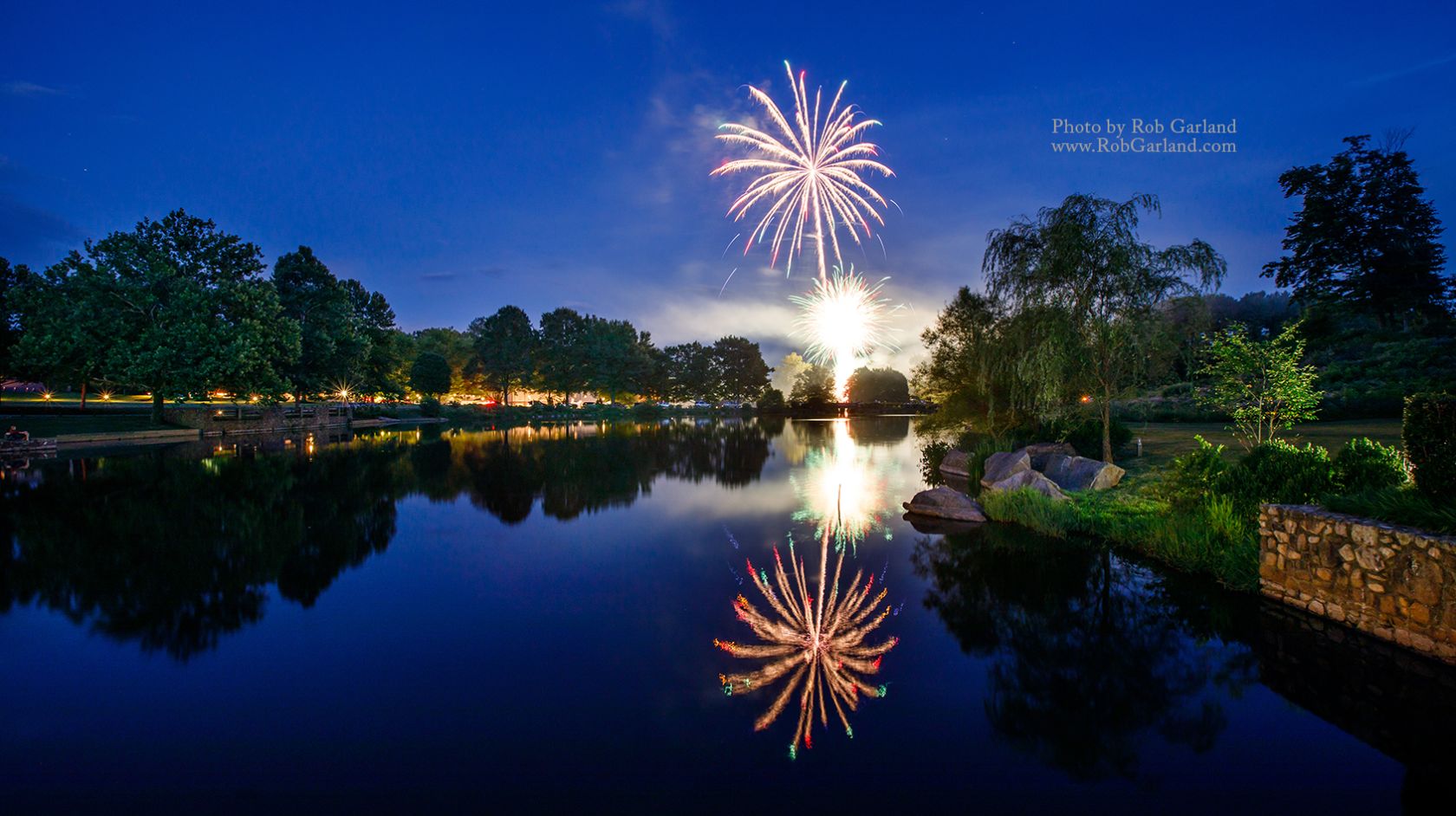 Fireworks In The Sky Over A Body Of Water