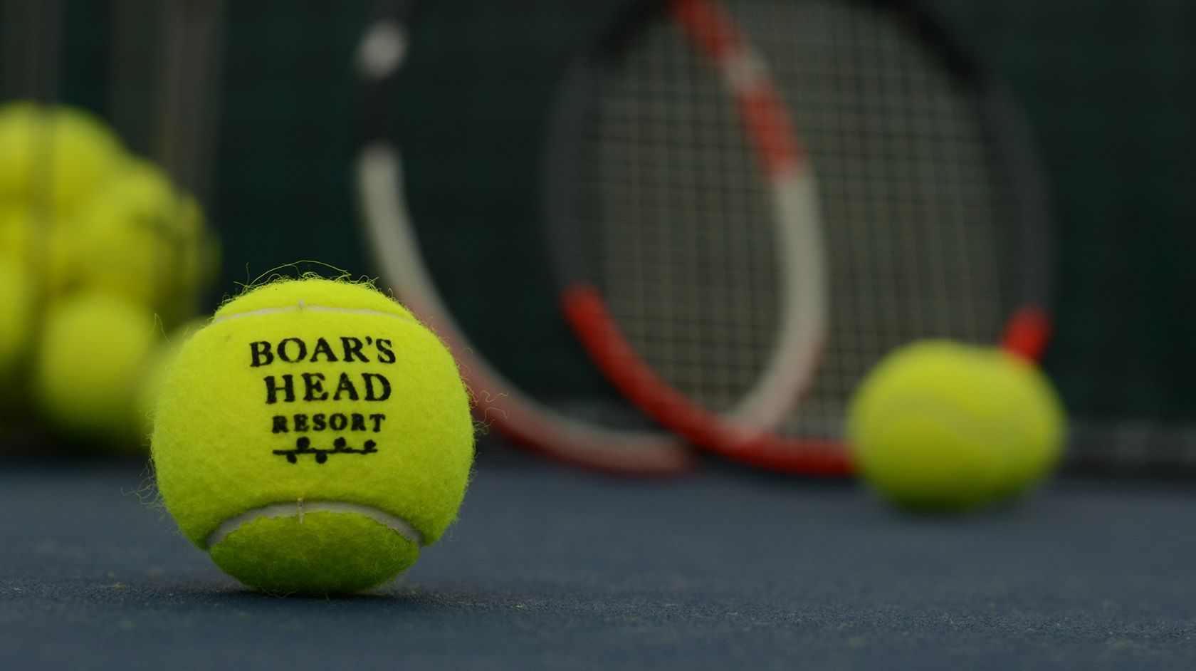 A Tennis Ball On A Court With A Racket