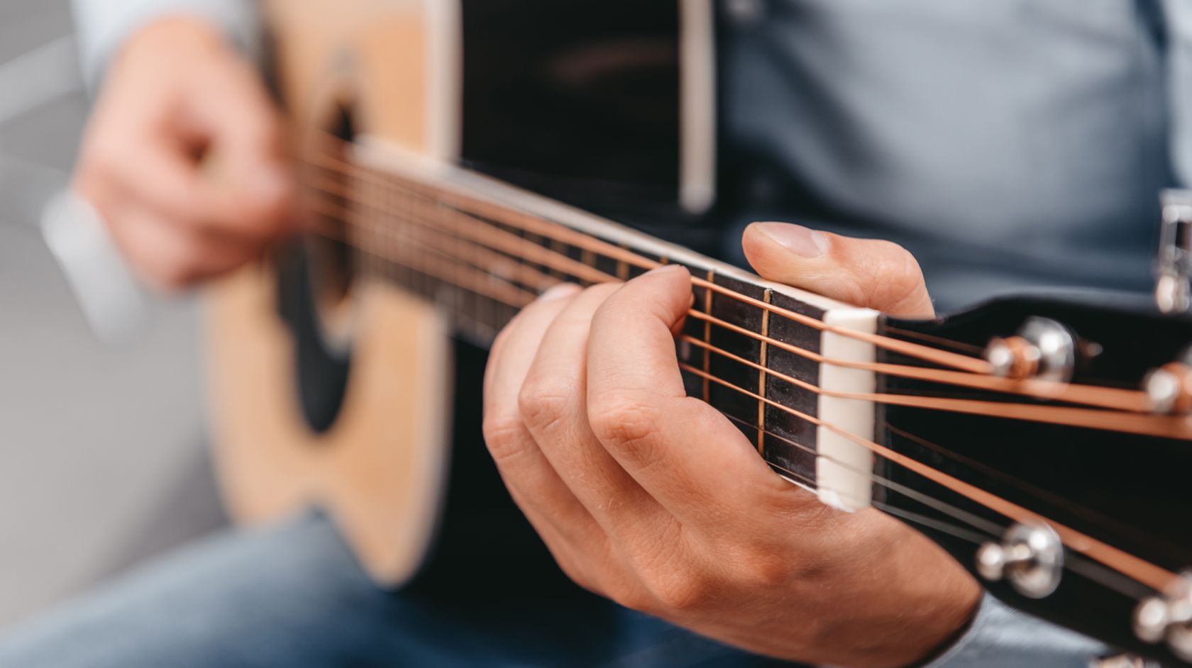 A Person Holding A Guitar
