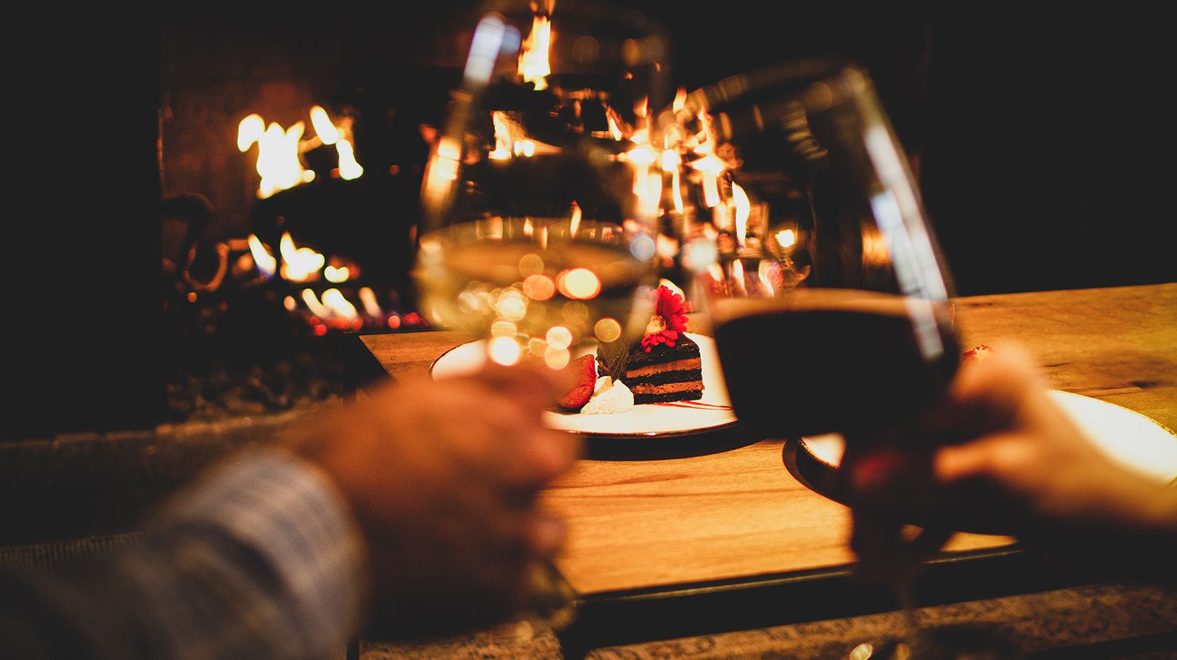 wine glasses in front of fire place
