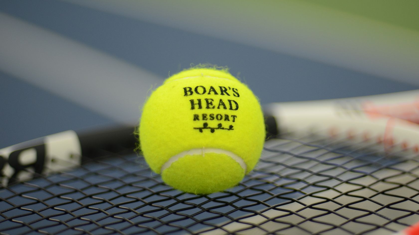 A Close Up Of A Ball With A Racket