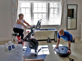 Peloton Room with Couple Exercising