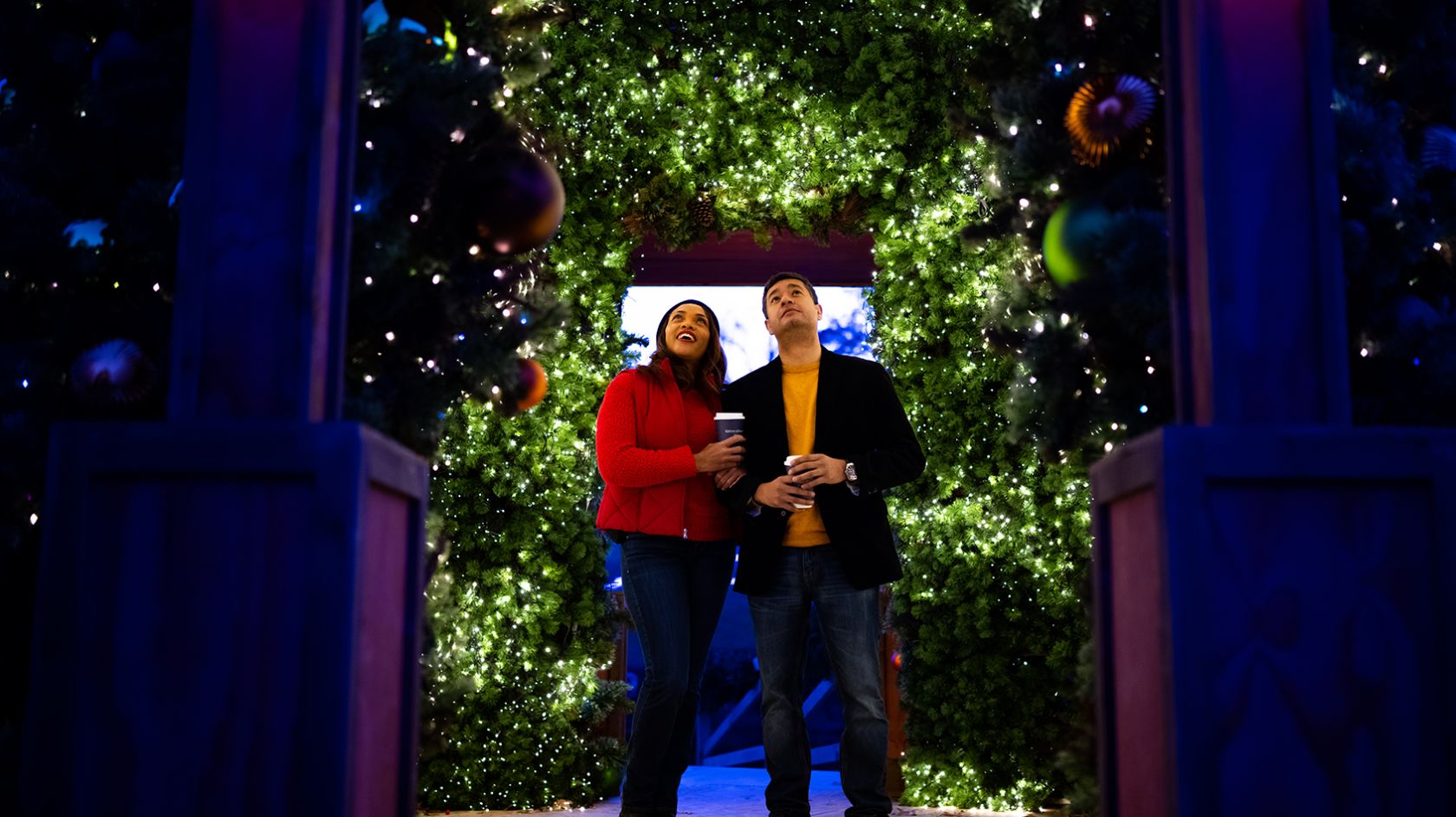 Couple around holiday lights display