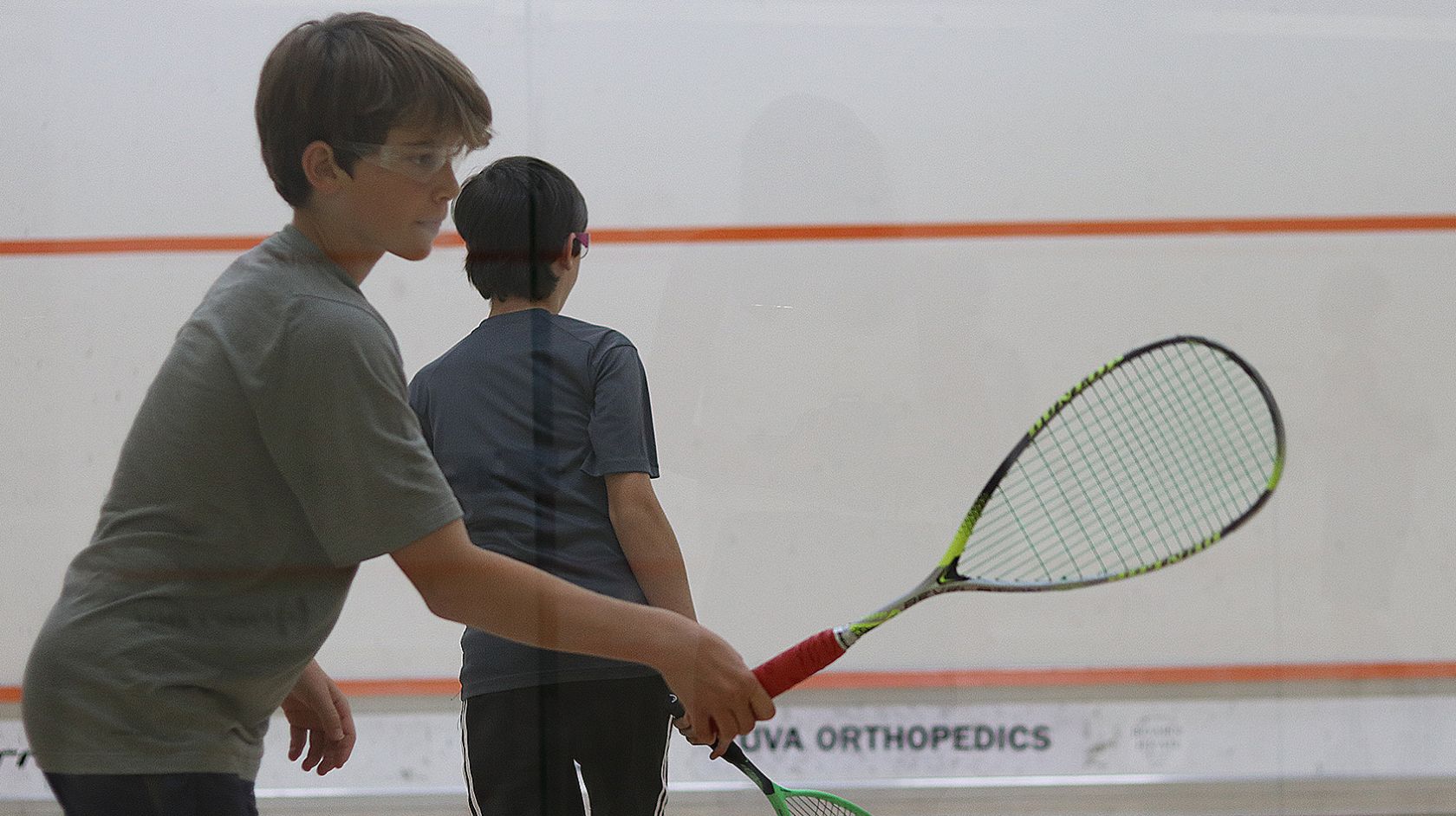 A Couple Of Boys Playing Squash
