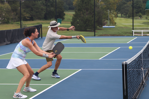 A Couple Of People Play Tennis