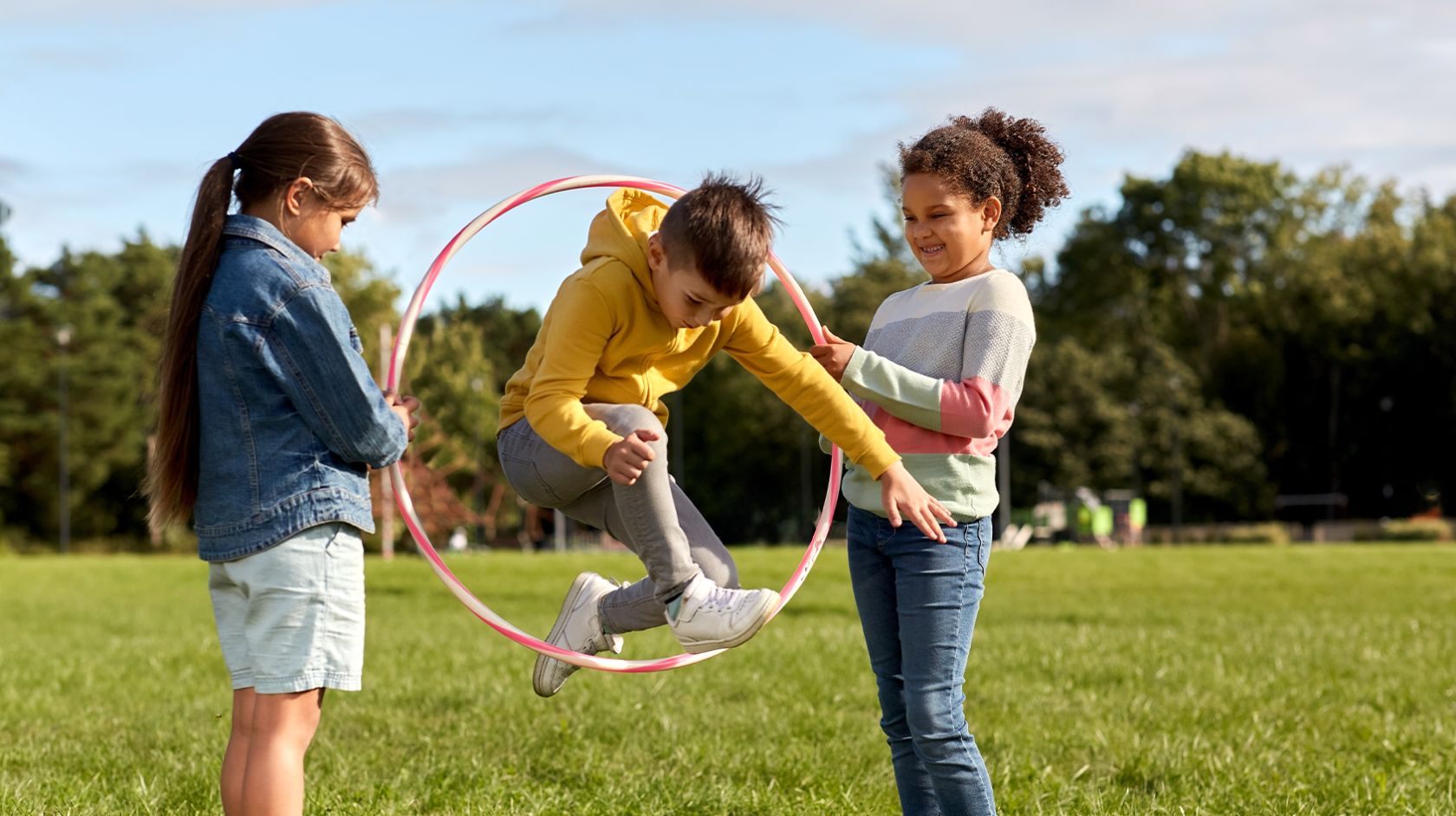 A Person And Two Children Playing With A Kite