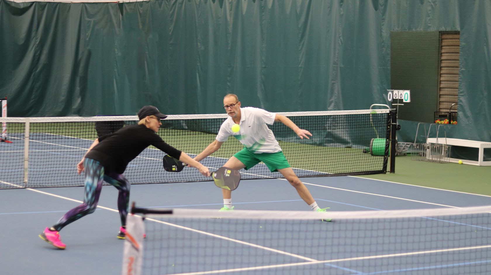 A Couple Of Men Playing Tennis